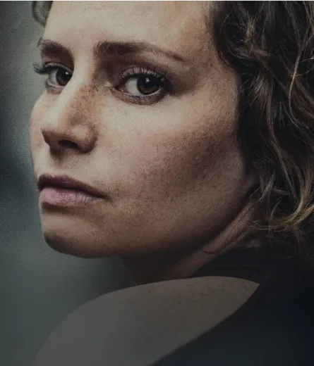 A woman looks behind her shoulder