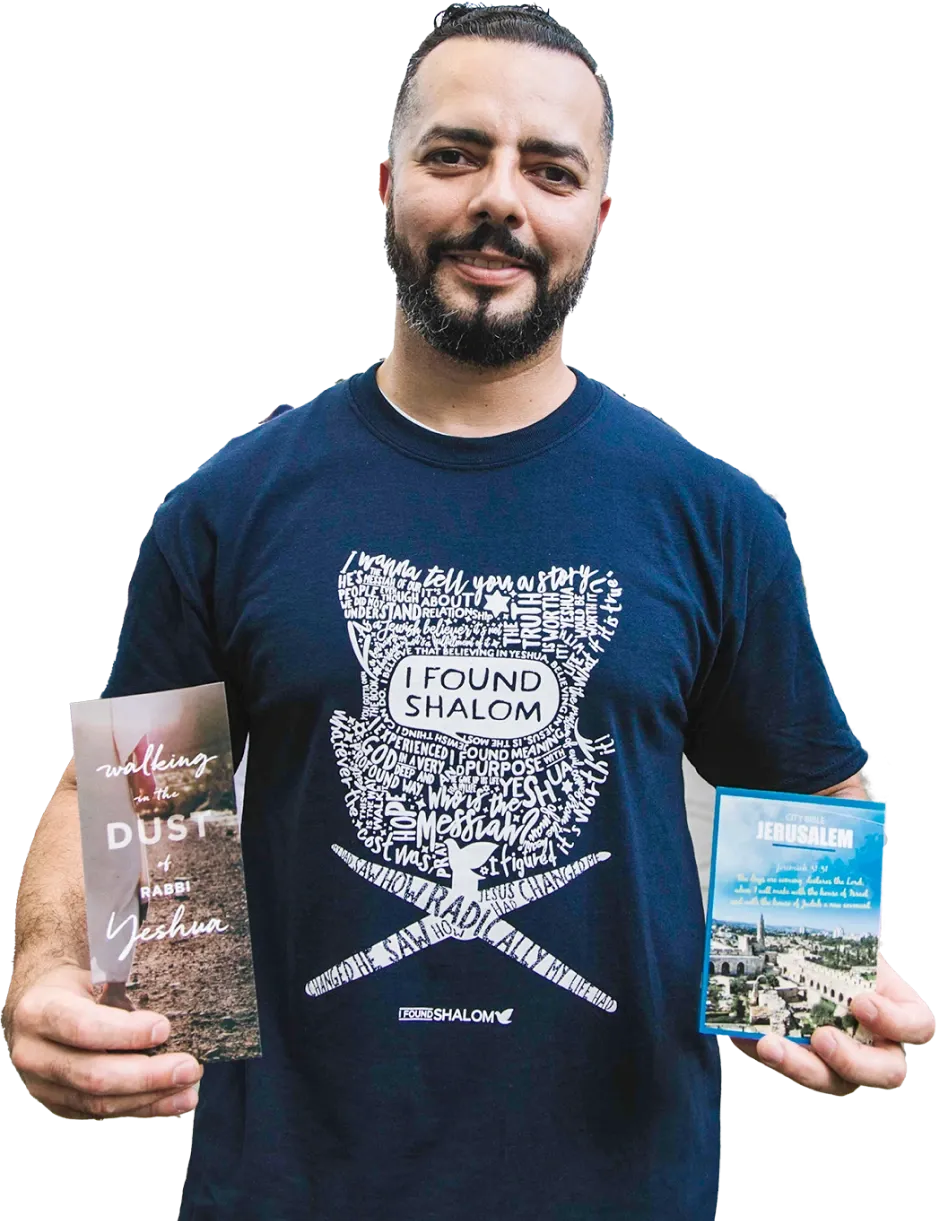 A staff member of Chosen People holds outreach brochures in both hands