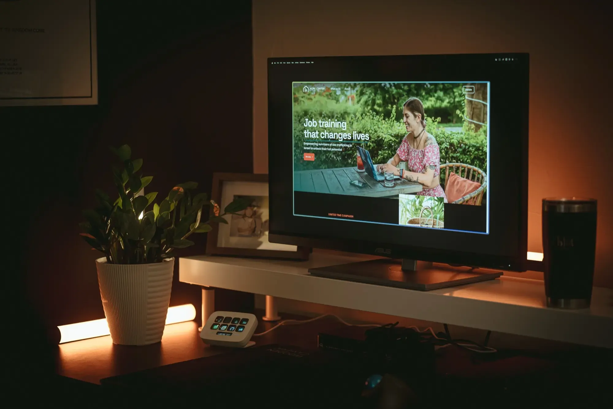 Hope Center's website is shown on a monitor in a warm and dimly lit office