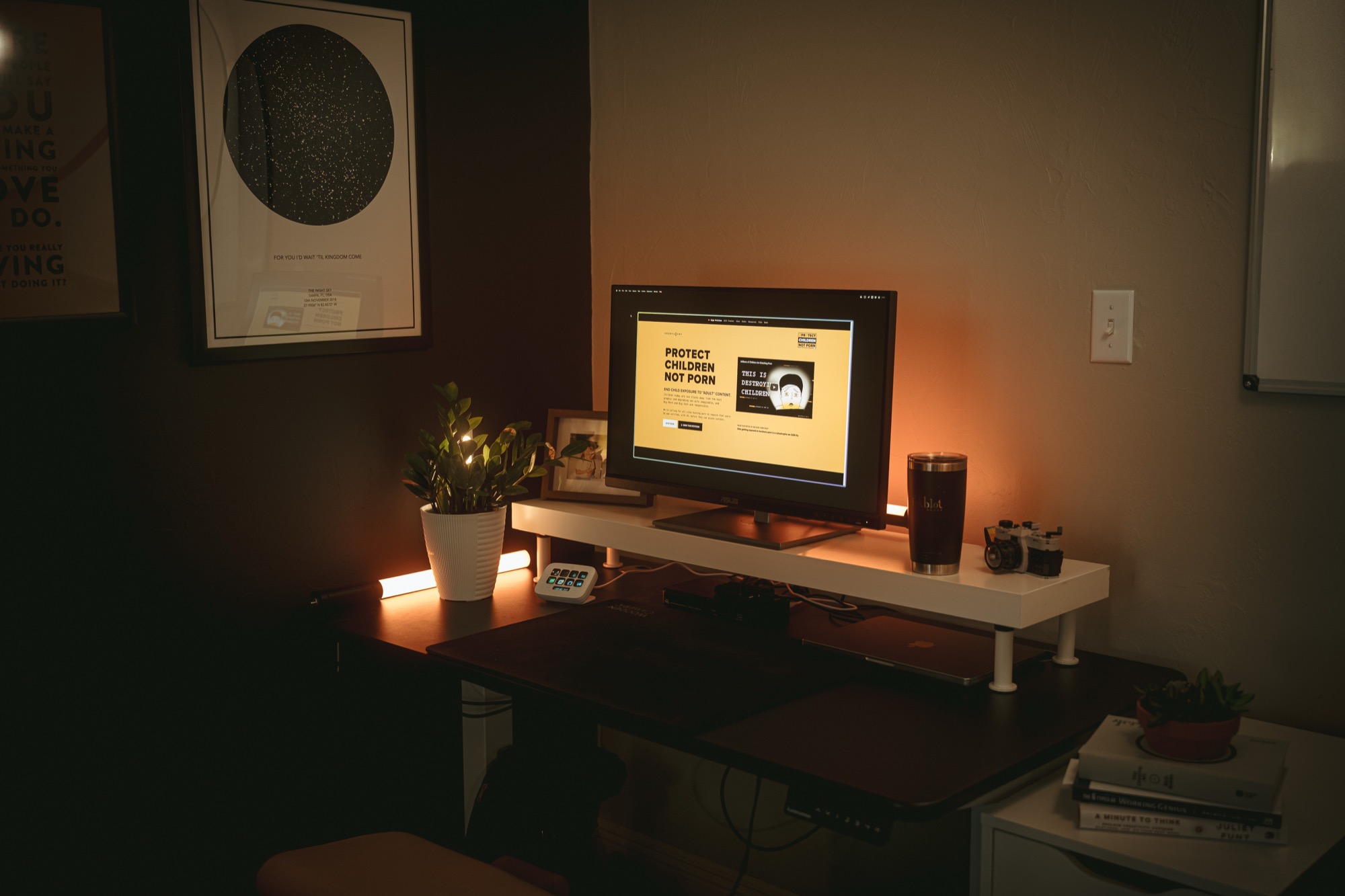 The Protect Children Not Porn campaign is shown on a desktop computer in a warm dimly lit office