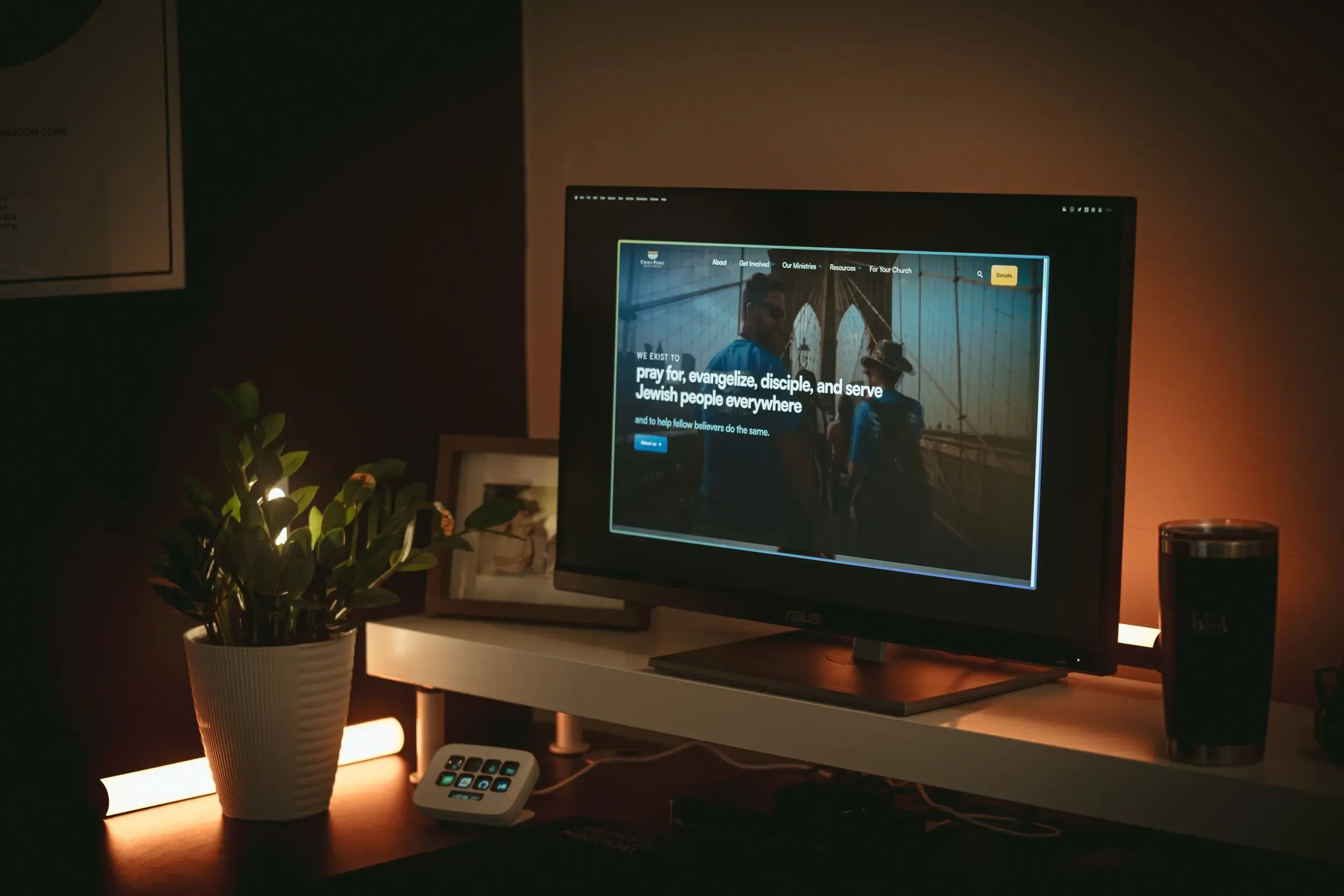 chosenpeople.com shows on a screen sitting on a dimly lit cozy desk