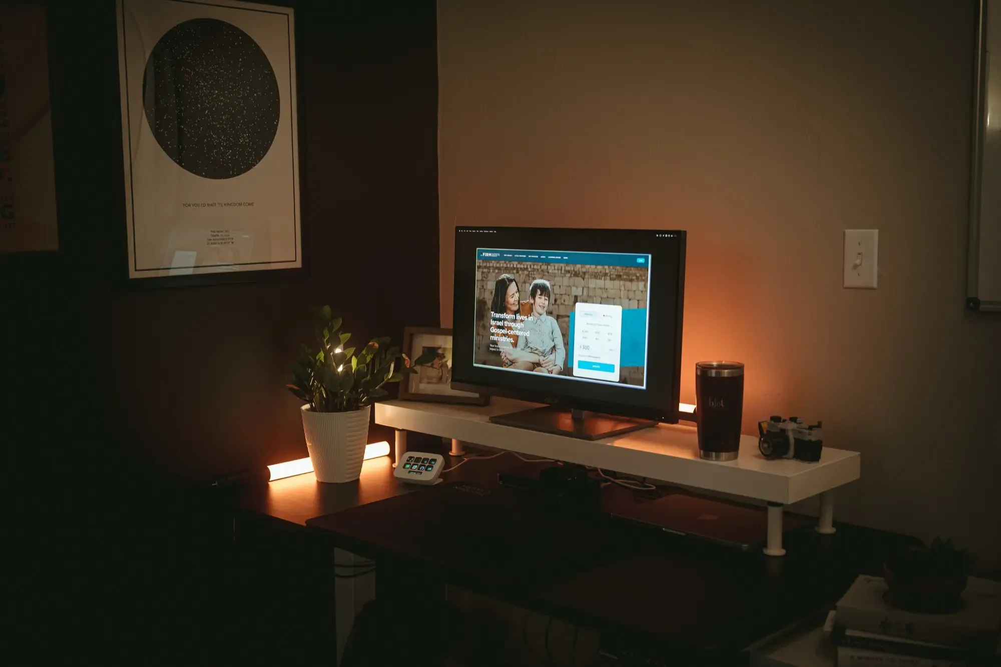 A dimly lit desk showcases firmisrael.org