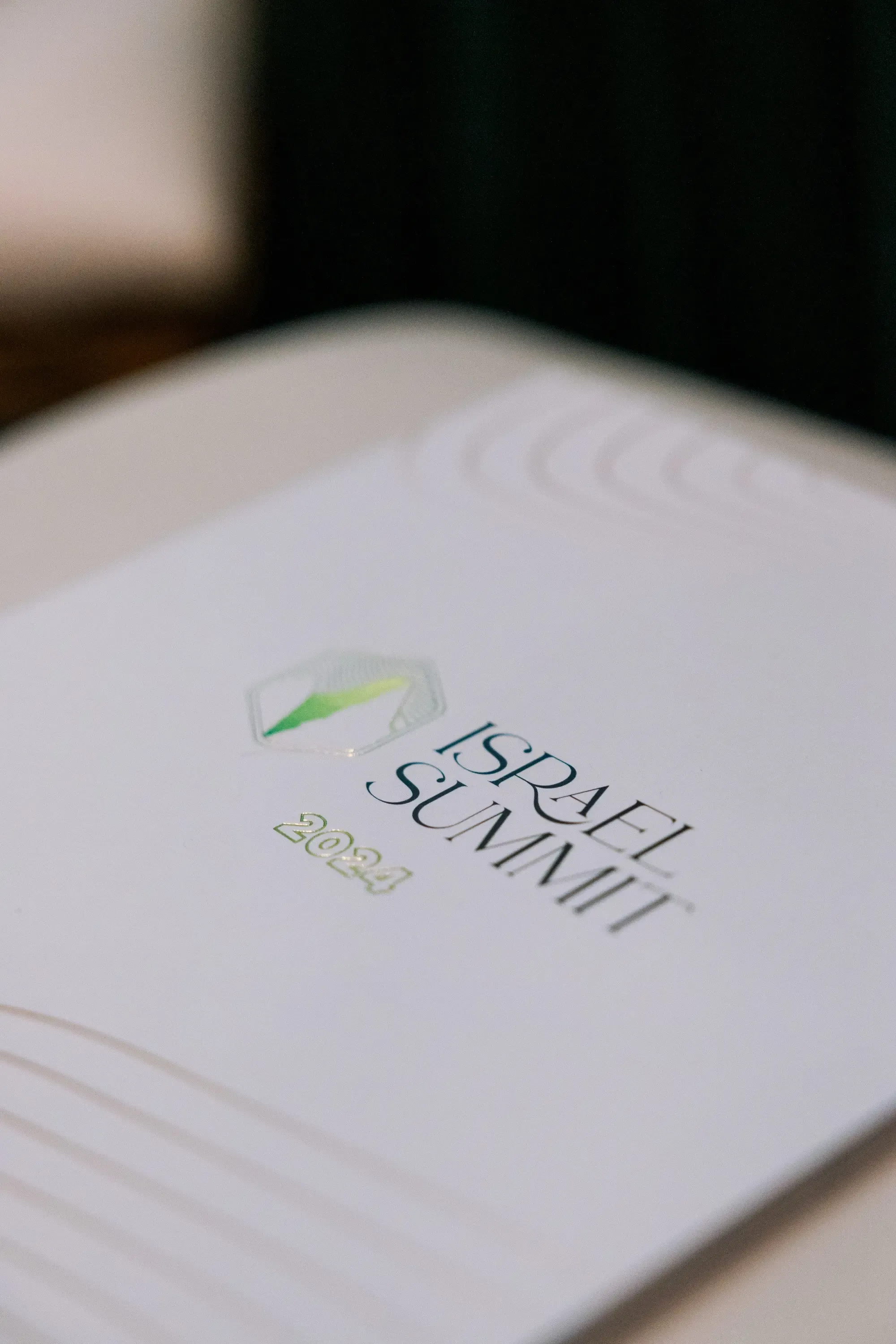 A close up of the Israel Summit booklet